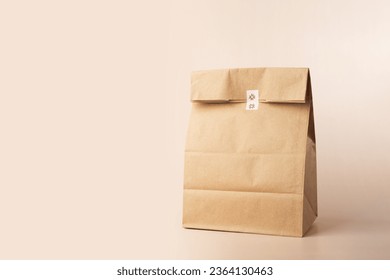 Take away bag, market shopping, folded paper sack, food delivery, responsible wrapping, copy space - Powered by Shutterstock