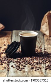 take away a coffee cup and coffee beans on wooden background