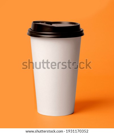 take away coffee on color background
