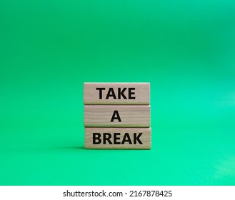 Take A Break Symbol. Concept Words 'Take A Break' On Wooden Blocks. Beautiful Green Background. Business And Take A Break Concept. Copy Space.