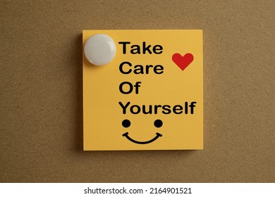 Take care of your self, Encouragement.Positive energy Concept.,Take Care Of Yourself word and smile,heart icon on yellow stickynote stick on board.