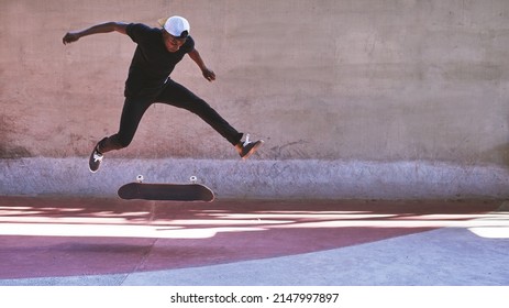 Take a chance. Shot of a young man doing tricks on his skateboard at the skatepark.