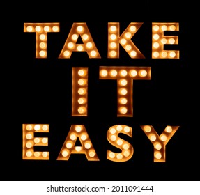 Take It Easy - Neon Inscription.  Signs. Style. Text. Neon Lights In A Store Front Window. A Sign That Is Easy For Customers To Take Notice.