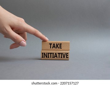 Take initiative symbol. Wooden blocks with words Take initiative. Beautiful grey background. Businessman hand. Business and Take initiative concept. Copy space. - Shutterstock ID 2207157127