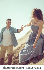 Take My Hand. Couple On Sand.