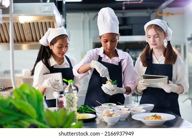 take note on book. Cooking class. culinary classroom. group of happy young woman multi-ethnic students are focusing on cooking lessons in a cooking school.  - Shutterstock ID 2166937949