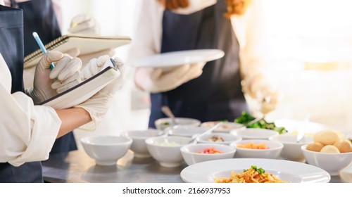 take note on book. Cooking class. culinary classroom. group of happy young woman multi-ethnic students are focusing on cooking lessons in a cooking school. 