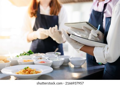 take note on book. Cooking class. culinary classroom. group of happy young woman multi-ethnic students are focusing on cooking lessons in a cooking school.  - Shutterstock ID 2166937957
