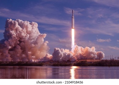 Take off space rocket on a background of blue sky and sun. Elements of this image were furnished by NASA. High quality photo - Shutterstock ID 2104918436