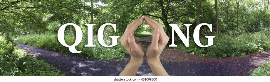 Take the Path to Qi Gong Healing - female hands making the O of the word GIGONG on a wide banner showing a three way path through a woodland scene