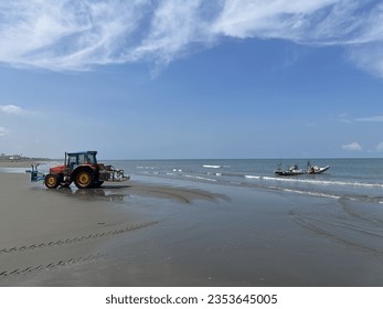 Take photos of fishermen pulling sampans ashore with trailers - Shutterstock ID 2353645005