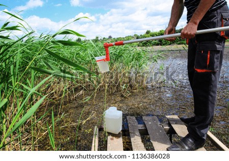 Take samples of water for laboratory testing. The concept - analysis of water purity, environment, ecology