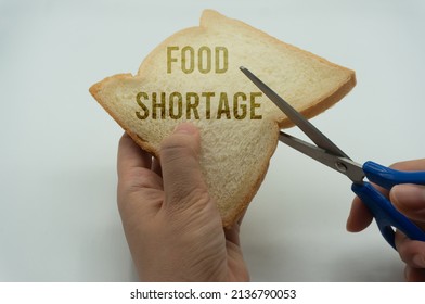 Take Scissors And Cut Bread. An Allusion To The World's Food Scarcity, Lack Of Food And Failure Of Agricultural Crops. Conservation And Waste. Shortage Of Supply. Economic Crisis.