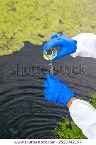 Take a water sample from the river. Selective focus. Nature.