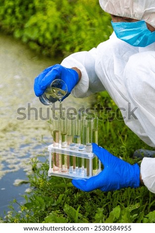 Take a water sample from the river. Selective focus. Nature.