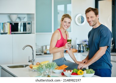 Take your health into your own hands. Portrait of a couple preparing a nutritious meal together at home.