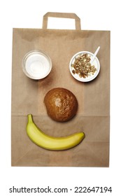 Takeaway Breakfast Food Arranged Into Smiley Face On Paper Bag