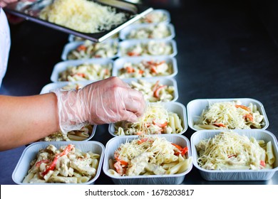 takeaway chicken salad with vegetables and cheese food delivery. preparing portions in containers. service food order online delivery in quarantine covid-19. airline food. airline meals and snacks