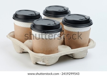 Takeaway delivery hot drinks theme. Paper cups in holder isolated