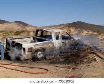 Taken In 2007. A Stolen Pickup Truck That Was Burned In The Arizona Desert. The Man On The Far Left Is A Volunteer Firefighter. No Model Release Is Necessary. 