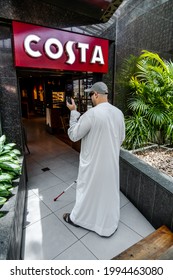 Taken at Dubai, United Arab Emirates on 29th of May 2021: Costa Coffee parters with RightHear - an app for the blind and visually impaired; Blind Arab man walking into the cafe while using the app.