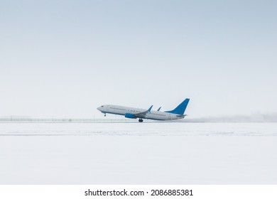 Takeoff of a passenger jet plane in a severe snowstorm