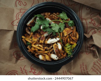 "Takeout bowl of stir-fried noodles with sliced chicken, vegetables, sesame seeds, and cilantro, fresh and ready to eat."