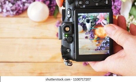 Takes A Photo With Still Life With Lilac Flowers And Cream Cosmetic By Photo Camera 