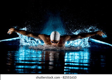 Taking breath swimming butterfly isolated black background