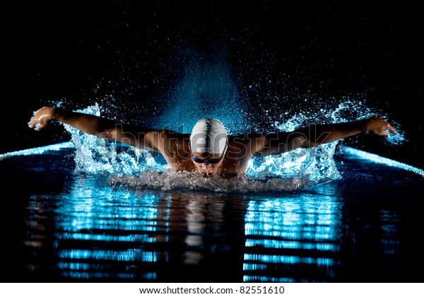 Taking breath swimming butterfly isolated\
black background