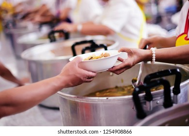 Taking care of the homeless by sharing food is the hope of the poor : the concept of begging and hunger. - Shutterstock ID 1254908866