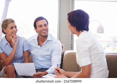 Taking Charge Of Their Finances. Shot Of A Couple Meeting With Their Financial Advisor.