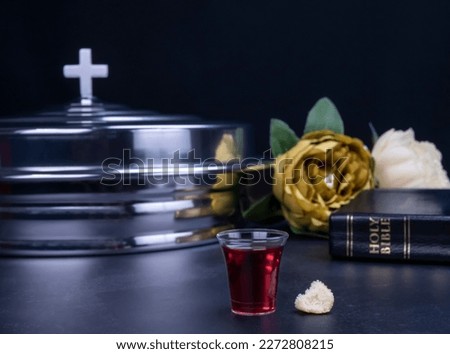 Taking communion concept - the wine and the bread symbols of Jesus Christ blood and body with Holy Bible. Easter Passover and Lord Supper concept.