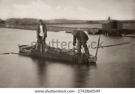 Taking Up the Eel-Net by Peter Henry Emerson and Thomas Frederick Goodall. Vintage black and white architecture photography.