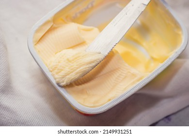 Taking Margarine From The Jar With The Knife