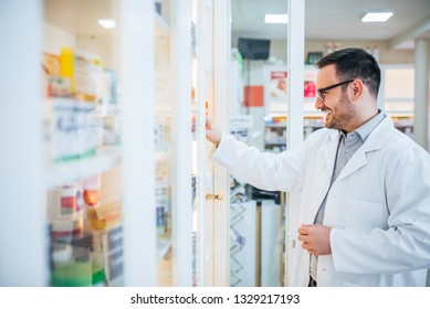 Taking Medicine From An Aisle In The Pharmaceutical Store.