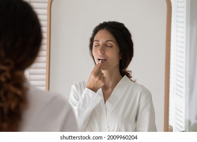 Taking Meds. Young Latin Woman Standing By Mirror At Bathroom Drinking Probiotic Multivitamin Tablet. Millennial Female In Morning Gown Swallowing Oral Contraceptive Pill Food Supplement Preparation