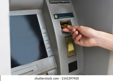 taking money with the card at the bank cashier - Shutterstock ID 1141397450