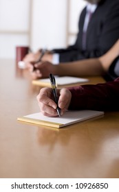 Taking Notes At A Business Meeting. Shallow Depth Of Field.