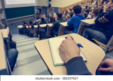 Taking notes at conference. - Shutterstock ID 583197457