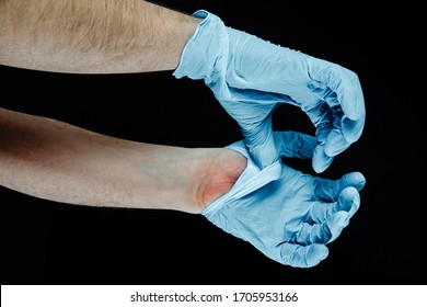 Taking Off Medical Gloves. Medical And Pharmaceutical Concept. Hand Protection Against Infection With Viruses, Bacteria. The Correct Method Of Taking Off Gloves, Safety.