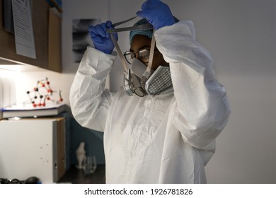 Taking Off Protective Mask. Portrait View Of The Doctor Or Nurse Taking Off Protective Mask While Coming At The Room After Hard Night Shift With Covid 19 Patients. Stock Photo