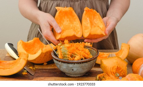 Taking out pumpkin seeds from fresh row orange pumpkin. Making pumpkin puree, step by step recipe, lifestyle