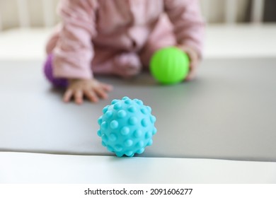 Taking photo of blue small ball using for baby development stage of fingers muscle. Blurred background. - Powered by Shutterstock