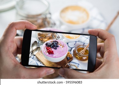 Taking Photos Of Breakfast To Phone. Social Media Concept. Sharing Healthy Food Photos