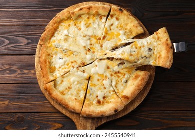 Taking piece of delicious cheese pizza at wooden table, top view - Powered by Shutterstock