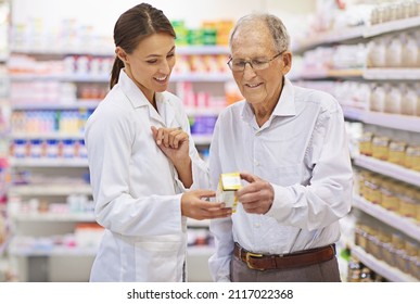 Taking the questions out of medication. Shot of a young pharmacist helping an elderly customer. - Powered by Shutterstock