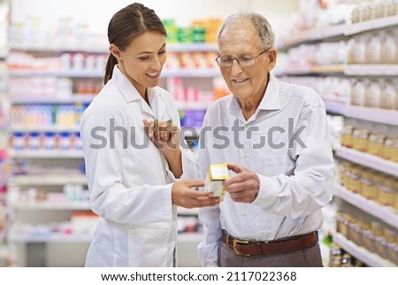 Taking the questions out of medication. Shot of a young pharmacist helping an elderly customer.
