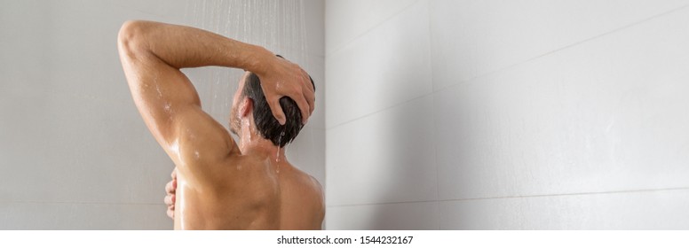 Taking a shower young man showering washing product shampoo from hair panorama banner home lifestyle background.