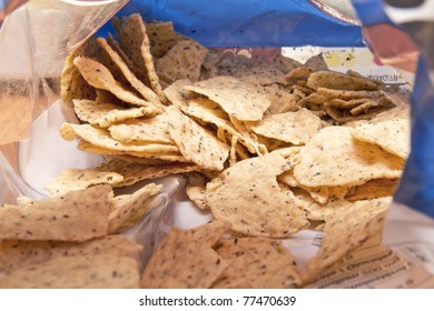 Taking A Sneak Peak Into A Bag Of Corn Tortilla Chips